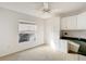 Bright bedroom with a built-in desk, white cabinets, ceiling fan, and window view at 2202 Kershaw Rd, The Villages, FL 32162