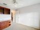 Cozy bedroom featuring a built-in shelving unit and neutral decor at 2202 Kershaw Rd, The Villages, FL 32162