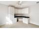 Corner built-in desk and cabinets with green counter tops in a bright bedroom featuring a ceiling fan and carpeted floors at 2202 Kershaw Rd, The Villages, FL 32162