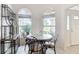Bright breakfast nook featuring large windows, a round table, and custom shelving for stylish, modern dining at 2202 Kershaw Rd, The Villages, FL 32162
