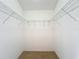 Spacious walk-in closet offering wire shelving and neutral carpeting at 2202 Kershaw Rd, The Villages, FL 32162