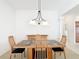 Bright dining room with a decorative chandelier and uniquely tiled table at 2202 Kershaw Rd, The Villages, FL 32162