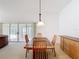 Bright dining area featuring a modern chandelier and access to the lanai at 2202 Kershaw Rd, The Villages, FL 32162