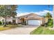 Charming single-story home with a brick driveway and manicured landscaping at 2202 Kershaw Rd, The Villages, FL 32162