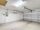 Well lit two-car garage with storage shelves and an automatic door opener at 2202 Kershaw Rd, The Villages, FL 32162