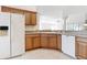 Bright kitchen featuring wood cabinets, white appliances, and ample counter space at 2202 Kershaw Rd, The Villages, FL 32162
