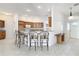 Open kitchen featuring breakfast bar and wood cabinets with ample counter space at 2202 Kershaw Rd, The Villages, FL 32162