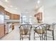 Bright kitchen with counter seating and view to the breakfast nook and dining space at 2202 Kershaw Rd, The Villages, FL 32162