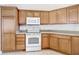 Classic kitchen design with wood cabinets and modern white appliances at 2202 Kershaw Rd, The Villages, FL 32162
