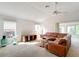 Cozy living room features a large sectional sofa and bright natural light at 2202 Kershaw Rd, The Villages, FL 32162