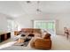Open living space with vaulted ceilings, fan, and sliding doors to the lanai at 2202 Kershaw Rd, The Villages, FL 32162