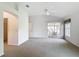 Spacious main bedroom with neutral carpet, ceiling fan, slider to lanai, and view of the backyard at 2202 Kershaw Rd, The Villages, FL 32162