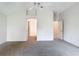 Spacious main bedroom with walk-in closet, ceiling fan, neutral walls, and easy access to the ensuite bathroom at 2202 Kershaw Rd, The Villages, FL 32162