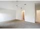 Large main bedroom featuring neutral carpet, ceiling fan, and a walk-in closet with plenty of room at 2202 Kershaw Rd, The Villages, FL 32162