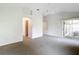 Spacious main bedroom featuring neutral carpet, ceiling fan, and access to an outdoor seating area at 2202 Kershaw Rd, The Villages, FL 32162
