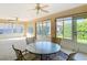 Bright sunroom with tile flooring, ceiling fans, and many windows for a view of the outdoors at 2202 Kershaw Rd, The Villages, FL 32162