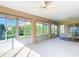 Bright sunroom featuring large windows and a ceiling fan at 2202 Kershaw Rd, The Villages, FL 32162