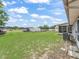 Expansive backyard featuring a chain-link fence, with additional storage and mature shade trees at 2242 Orkney Dr, Leesburg, FL 34788