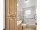 Bright bathroom with tiled tub and shower features a wooden vanity at 2242 Orkney Dr, Leesburg, FL 34788