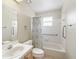 Bright bathroom with accessible tub and shower features a neutral vanity at 2242 Orkney Dr, Leesburg, FL 34788