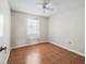 Bright bedroom features a ceiling fan and wood parquet flooring at 2242 Orkney Dr, Leesburg, FL 34788