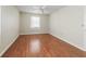 Inviting bedroom features a ceiling fan and natural light from the window at 2242 Orkney Dr, Leesburg, FL 34788