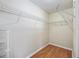 Walk-in closet with organizers and hardwood floors at 2242 Orkney Dr, Leesburg, FL 34788