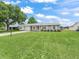 Inviting single-story home showcasing a lush front lawn, an attached garage and a tidy exterior at 2242 Orkney Dr, Leesburg, FL 34788