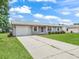 Classic single-story home boasting a well-kept lawn, attached garage, and a tidy exterior at 2242 Orkney Dr, Leesburg, FL 34788
