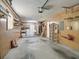 Spacious garage featuring a laundry area and utility shelving at 2242 Orkney Dr, Leesburg, FL 34788