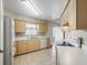 Bright kitchen featuring tile floors, wood cabinets and modern appliances at 2242 Orkney Dr, Leesburg, FL 34788