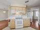 Bright kitchen featuring white appliances, laminate counters and tile floor at 2242 Orkney Dr, Leesburg, FL 34788