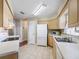 Bright kitchen featuring tile floors, wood cabinets and modern appliances at 2242 Orkney Dr, Leesburg, FL 34788