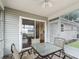 The enclosed lanai is furnished with a glass table and seating at 2242 Orkney Dr, Leesburg, FL 34788