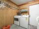 Well-organized laundry room features shelving, washer, and dryer at 2242 Orkney Dr, Leesburg, FL 34788