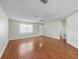 Bright living room featuring hardwood floors, a ceiling fan, and plenty of space for relaxation at 2242 Orkney Dr, Leesburg, FL 34788
