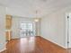 Bright living room featuring hardwood floors and access to sliding glass doors which lead to an outdoor area at 2242 Orkney Dr, Leesburg, FL 34788