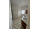Bathroom featuring double sinks, tile floors, a large mirror, and a walk-in shower at 23130 Brouwertown Rd, Howey In The Hills, FL 34737