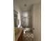 Bathroom featuring a single sink vanity and a shower-tub combo with glass doors at 23130 Brouwertown Rd, Howey In The Hills, FL 34737