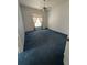 Spacious bedroom with blue carpet and window, providing great natural light at 23130 Brouwertown Rd, Howey In The Hills, FL 34737