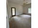 Spacious bedroom featuring an exterior door and a window with lots of natural light at 23130 Brouwertown Rd, Howey In The Hills, FL 34737