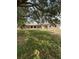 Ranch style house with a covered front porch and mature trees on a large lot at 23130 Brouwertown Rd, Howey In The Hills, FL 34737