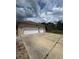 Exterior shot of the house, showing the two-car garage and spacious driveway at 23130 Brouwertown Rd, Howey In The Hills, FL 34737