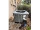 Exterior shot of the gray HVAC unit, set near the home and surrounded by foliage and mulch at 23130 Brouwertown Rd, Howey In The Hills, FL 34737