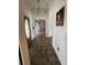 Hallway featuring tile flooring, a unique light fixture, and painting on the wall at 23130 Brouwertown Rd, Howey In The Hills, FL 34737