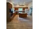 View of open kitchen with stainless steel appliances, center island, and wood cabinets at 23130 Brouwertown Rd, Howey In The Hills, FL 34737