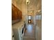 Bright laundry room featuring wooden cabinets, wood-look floors, and a washer and dryer at 23130 Brouwertown Rd, Howey In The Hills, FL 34737