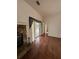 Inviting living room with hardwood floors, stone fireplace, and sliding glass doors at 23130 Brouwertown Rd, Howey In The Hills, FL 34737