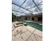 Screened-in pool with jacuzzi featuring a spacious deck perfect for entertaining at 23130 Brouwertown Rd, Howey In The Hills, FL 34737