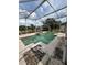 A caged pool with a built-in hot tub is ready for outdoor fun at 23130 Brouwertown Rd, Howey In The Hills, FL 34737